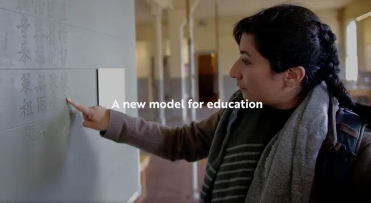 Image of a student reading the poetry inscribed on the walls of the Angel Island immigration detention barracks. Text over the image reads "A new model for education."