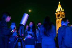 Photo of students looking through a telescope