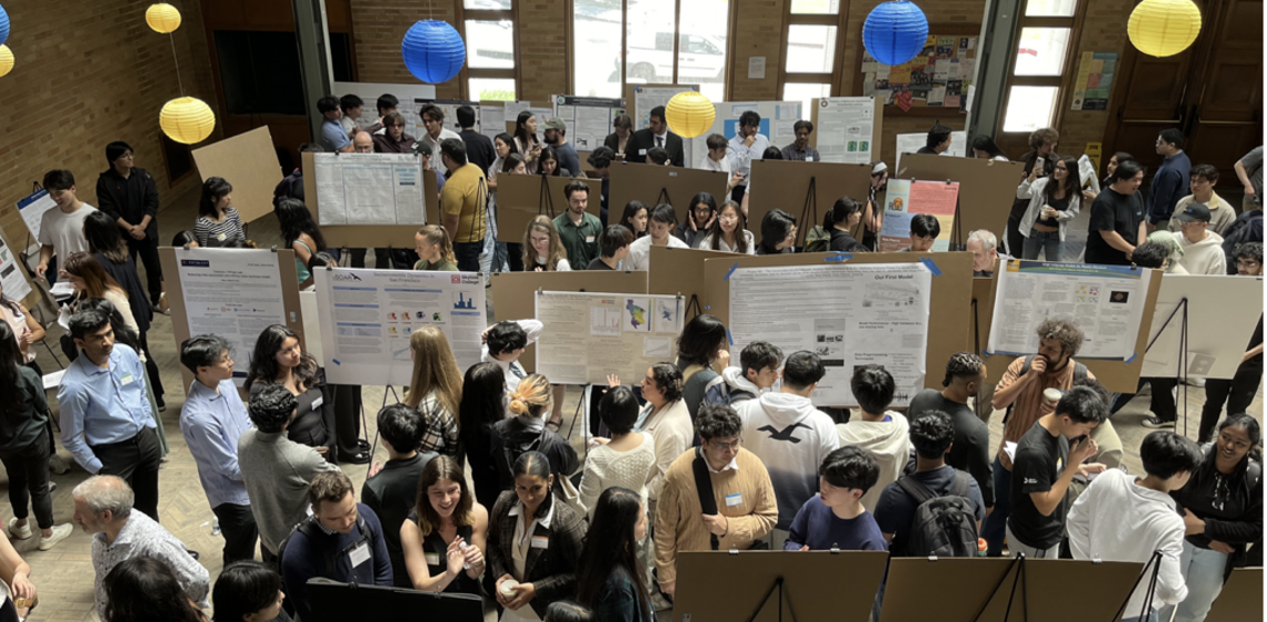 Students presenting posters in an auditorium