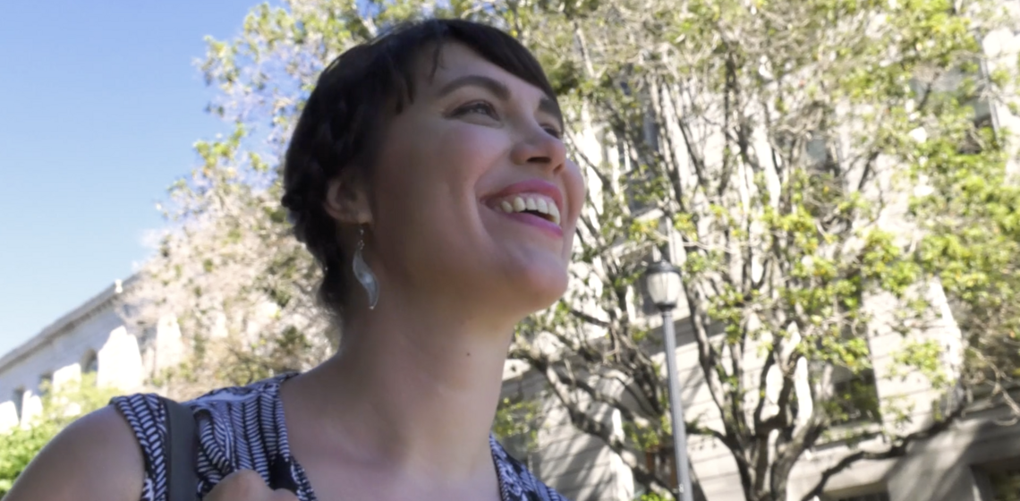 An upward angle of Tessa Rissacher smiling outdoors
